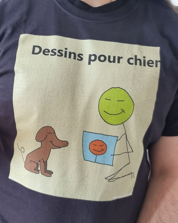 A t-shirt showing a character showing a drawing to a dog, under the text "Dessins pour chien"