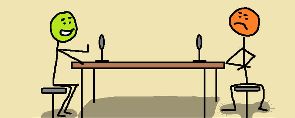 Two people a a podcast table