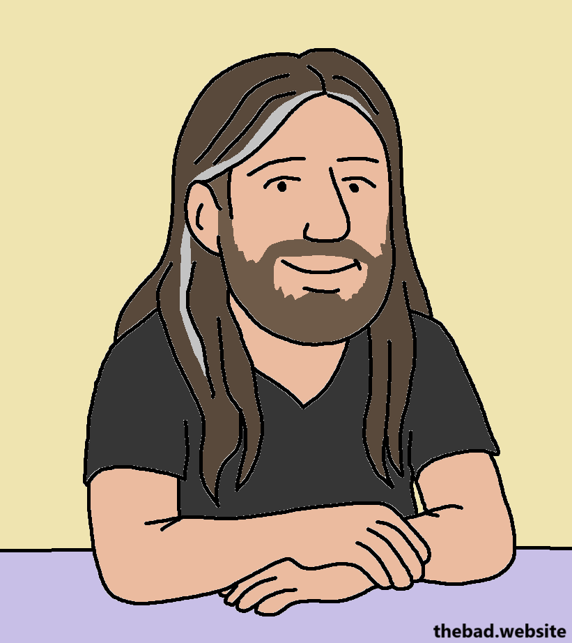 A man with long hair, a short beard, and crossed arms smiles at the viewer