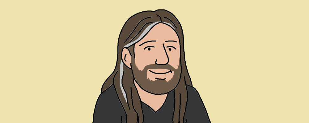 A smiling man with long hair