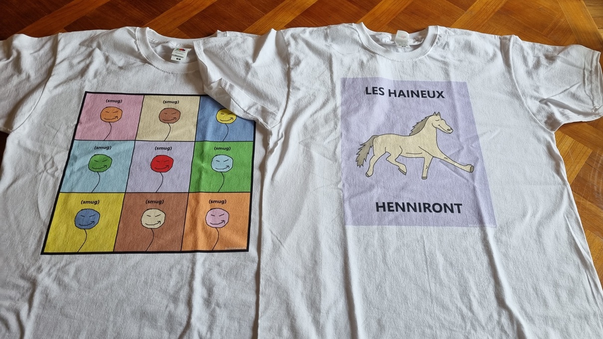Two t-shirts, one is a display of nine different smug characters, one is a horse parading between the text "LES HAINEUX HENNIRONT"